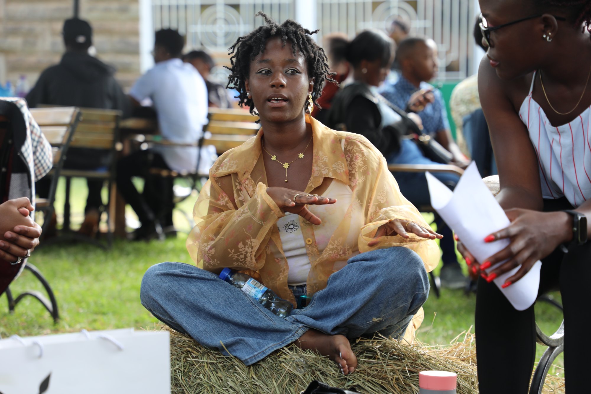 Young woman sharing story at FSN Social Clinic outdoor gathering