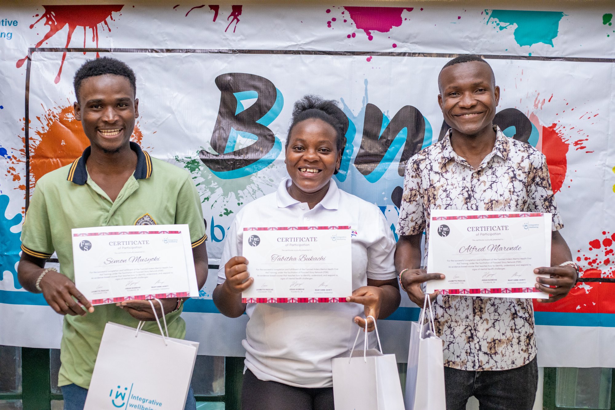 Fancied Aiders graduates proudly holding MHFA certificates